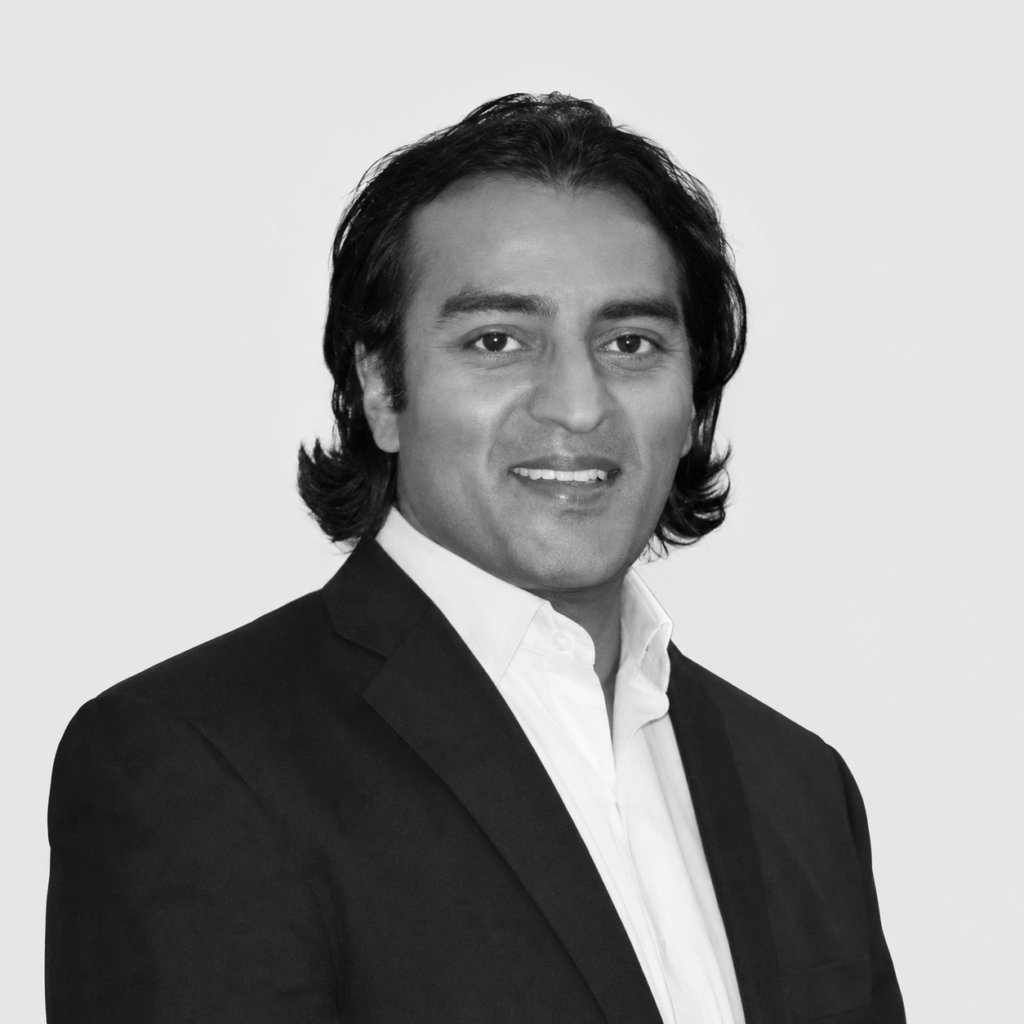 Black-and-white headshot of Marc Goodman, smiling and wearing a dark jacket and white shirt.