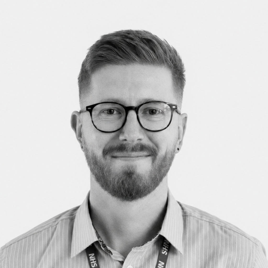 Black-and-white headshot of Mike Dahl, wearing glasses, a striped shirt and an NHS lanyard.